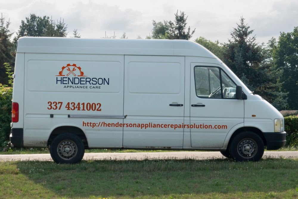 A parked van on grass features a sign that reads "Hengersen," promoting an appliance repair service in Henderson, NV.