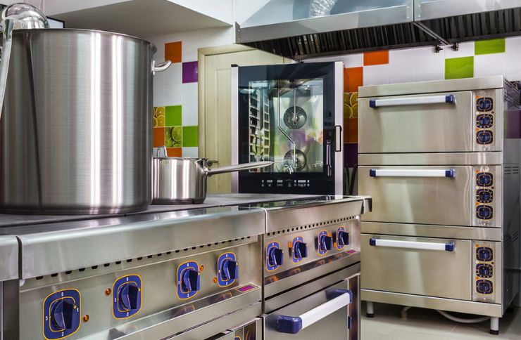A sleek kitchen showcasing stainless steel appliances and pots, associated with a commercial appliance repair service in Henderson, NV.